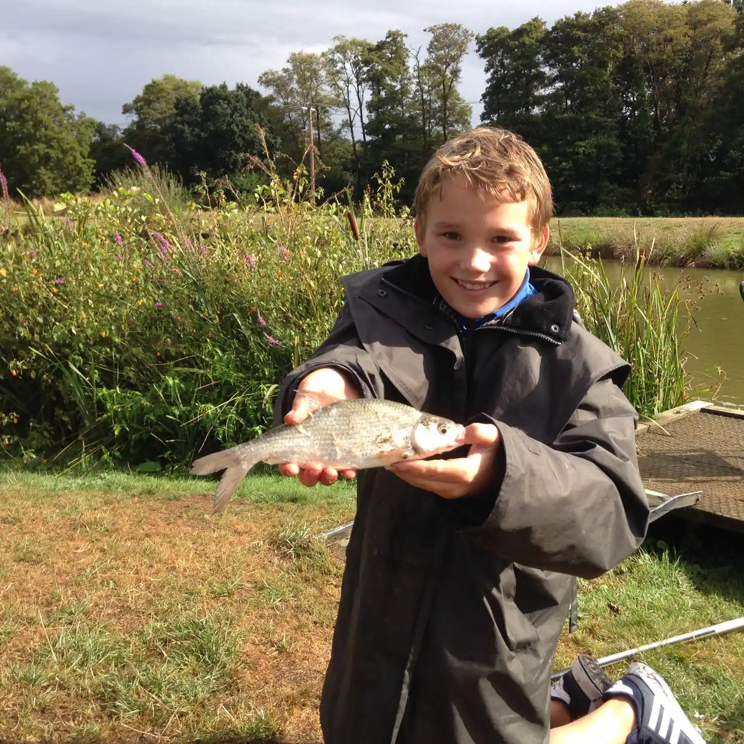 Nine year old boy trout fishing at Church Paddock Trout Fishery