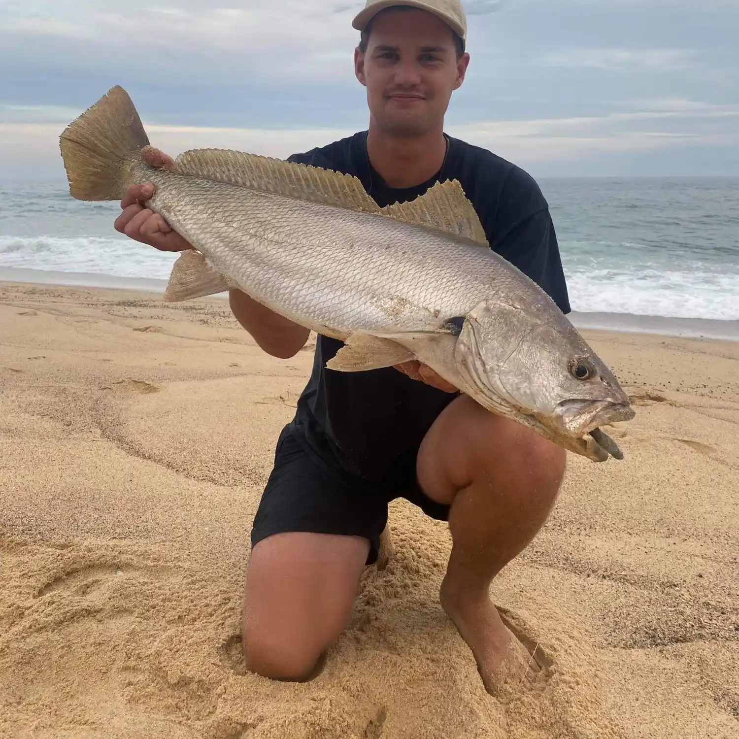 Image of Boys fishing from breakwall at Stockton Beach, NSW