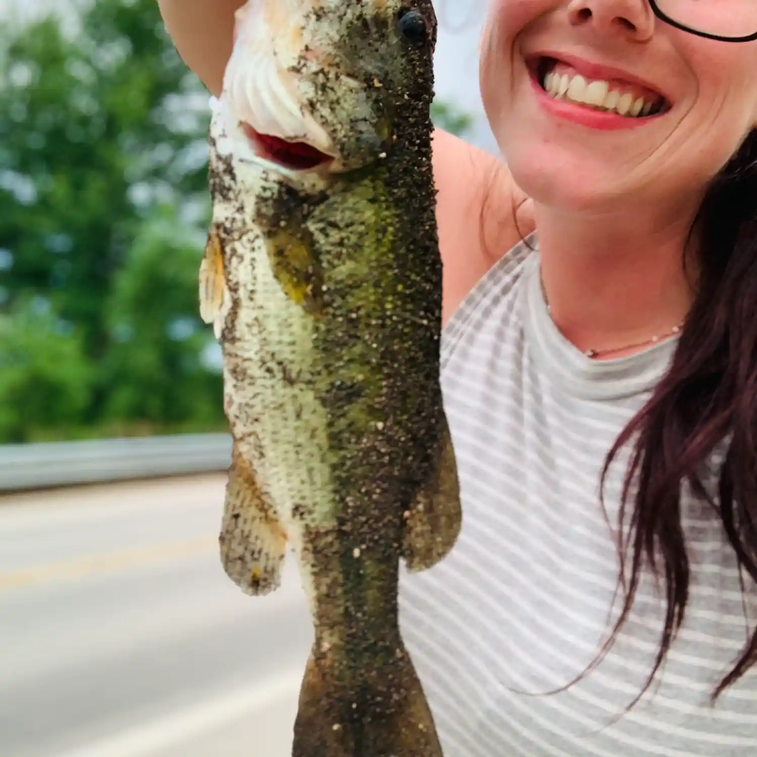 Woman Holding Very Small Fish On End Of Fishing Line With Disappointed  Expression by Stocksy Contributor Matthew Spaulding - Stocksy